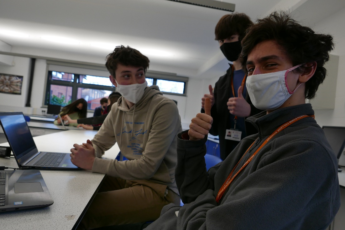 An image of 3 students working on there pcb